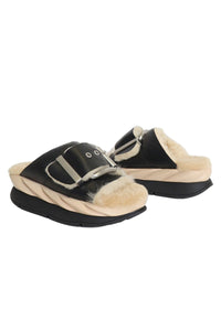 Black and beige slip-on shoes with fur lining on a white background